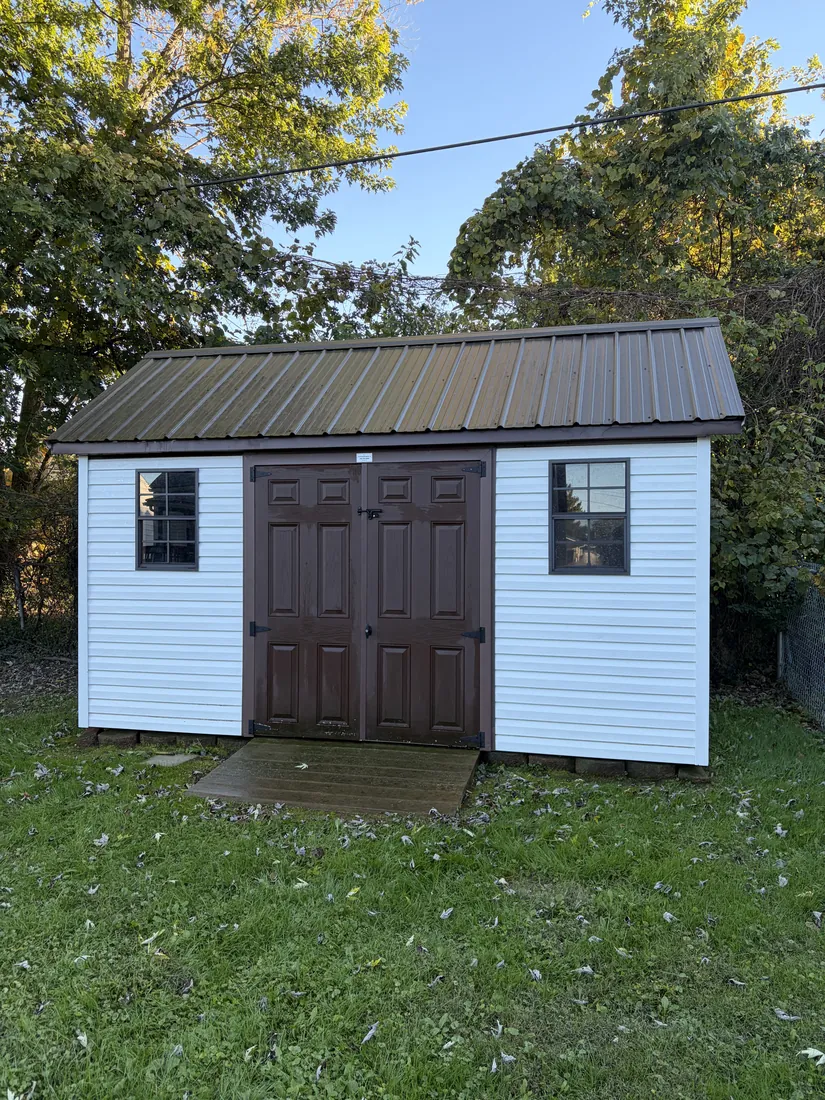 After: shed with clean white siding